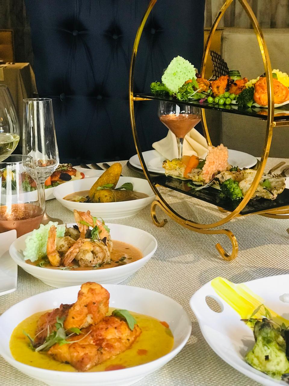 Fine dining spread with prawns and wine