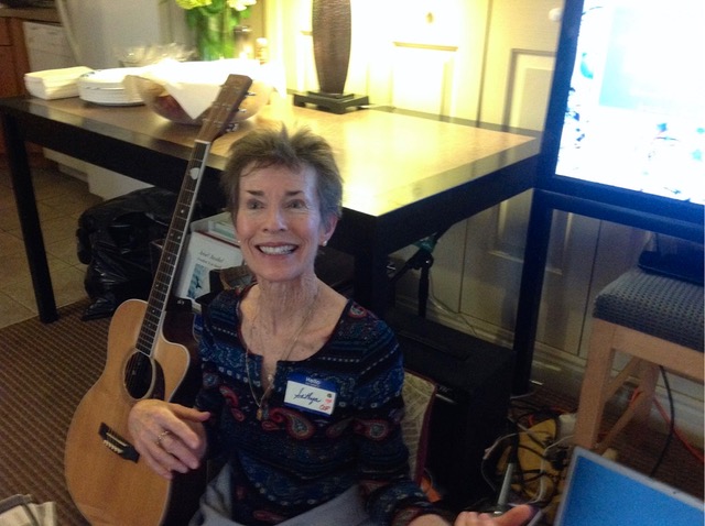 Linda D. Gallagher with guitar at event