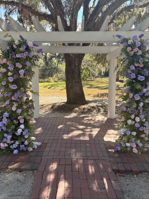 Hem of Grace Events garden pergola purple florals luxury event designer
