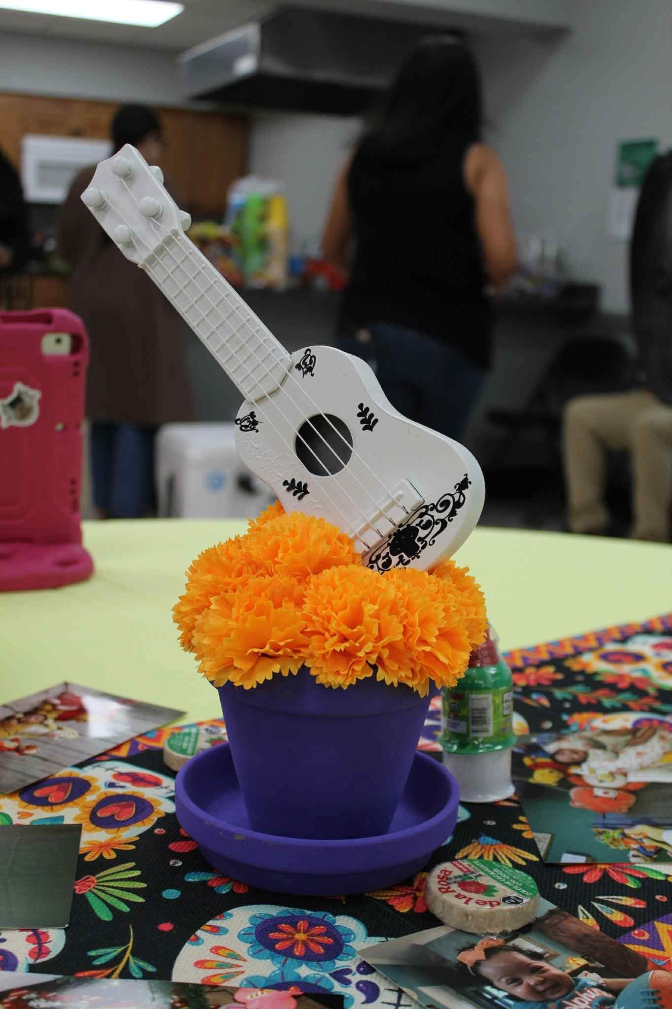 Hem of Grace Events centerpiece with guitar marigolds Florida event planner
