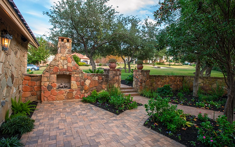 M&L Exterior Design — Premium stone walkway with hand-built fireplace