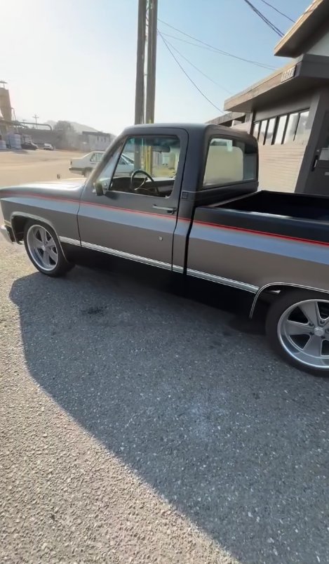 Gray and black truck with red stripe