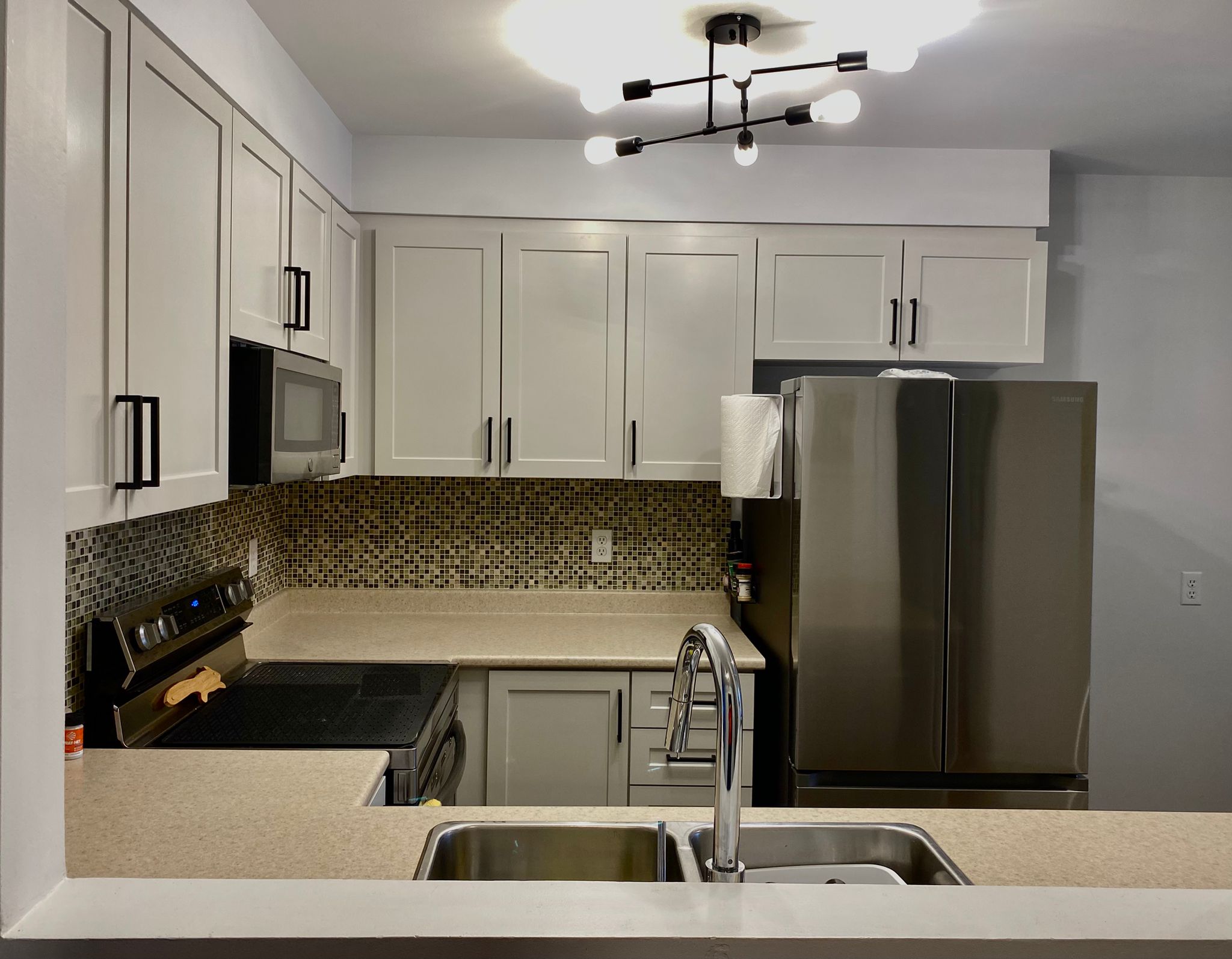 After refinish — Cathedral oak → white shaker, black hardware
