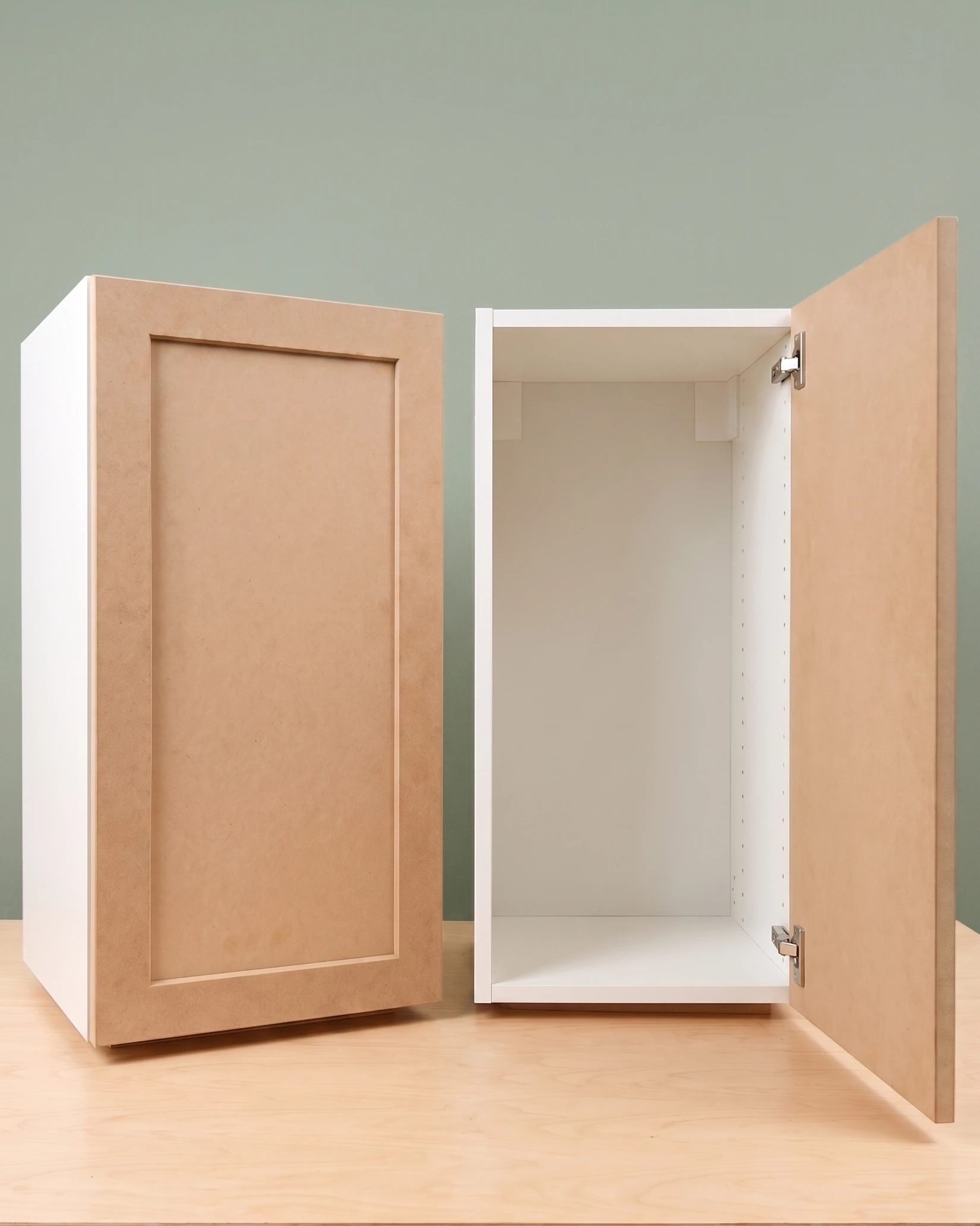 Ready To Paint MDF replacement door installed on an IKEA Sektion upper cabinet beside an empty Sektion cabinet box — the IKEA hack in one shot