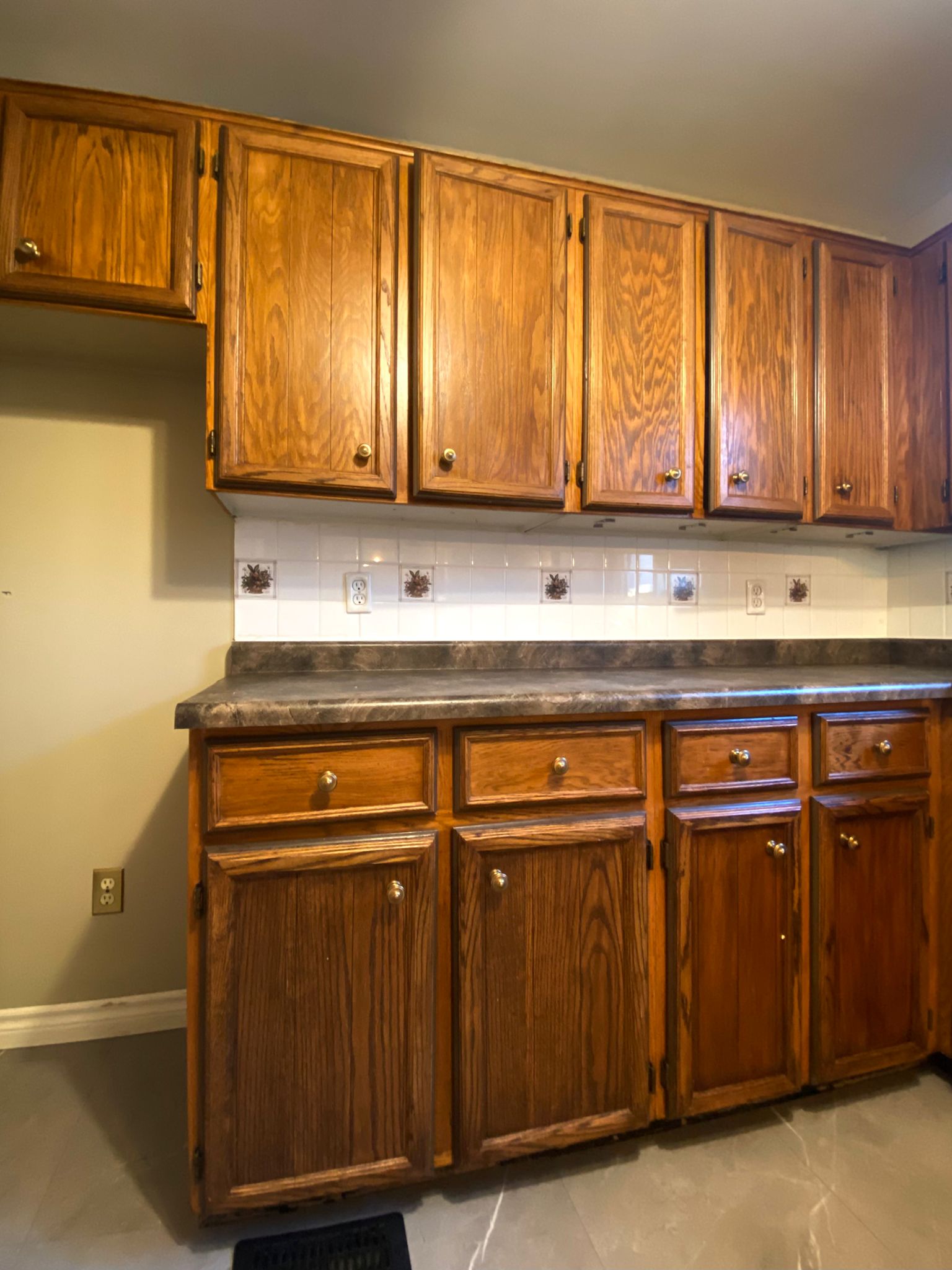 Before refinish — Honey oak → white shaker, brushed nickel pulls