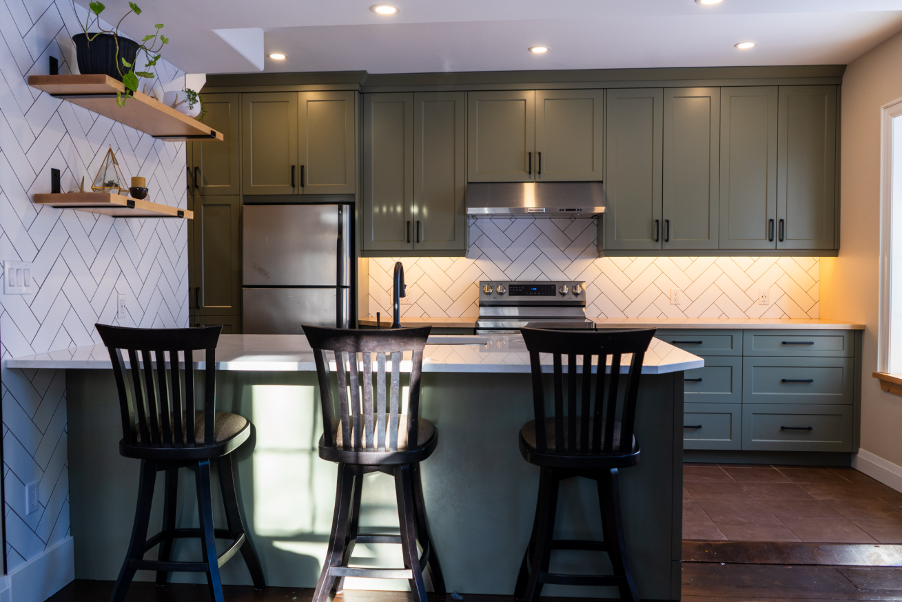 Belmont Custom Cabinetry โ olive green Shaker kitchen with herringbone backsplash