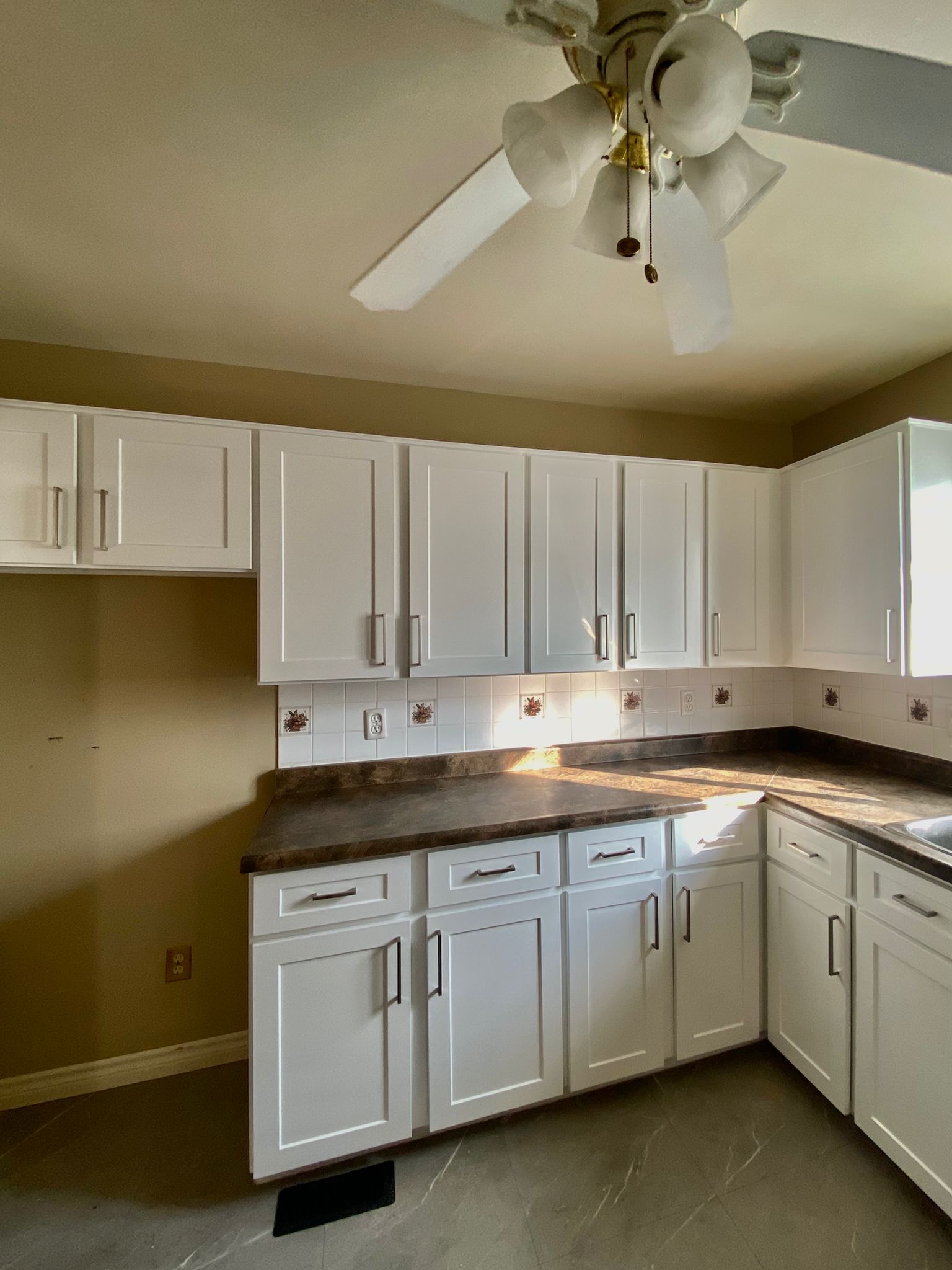 After refinish — Honey oak → white shaker, brushed nickel pulls