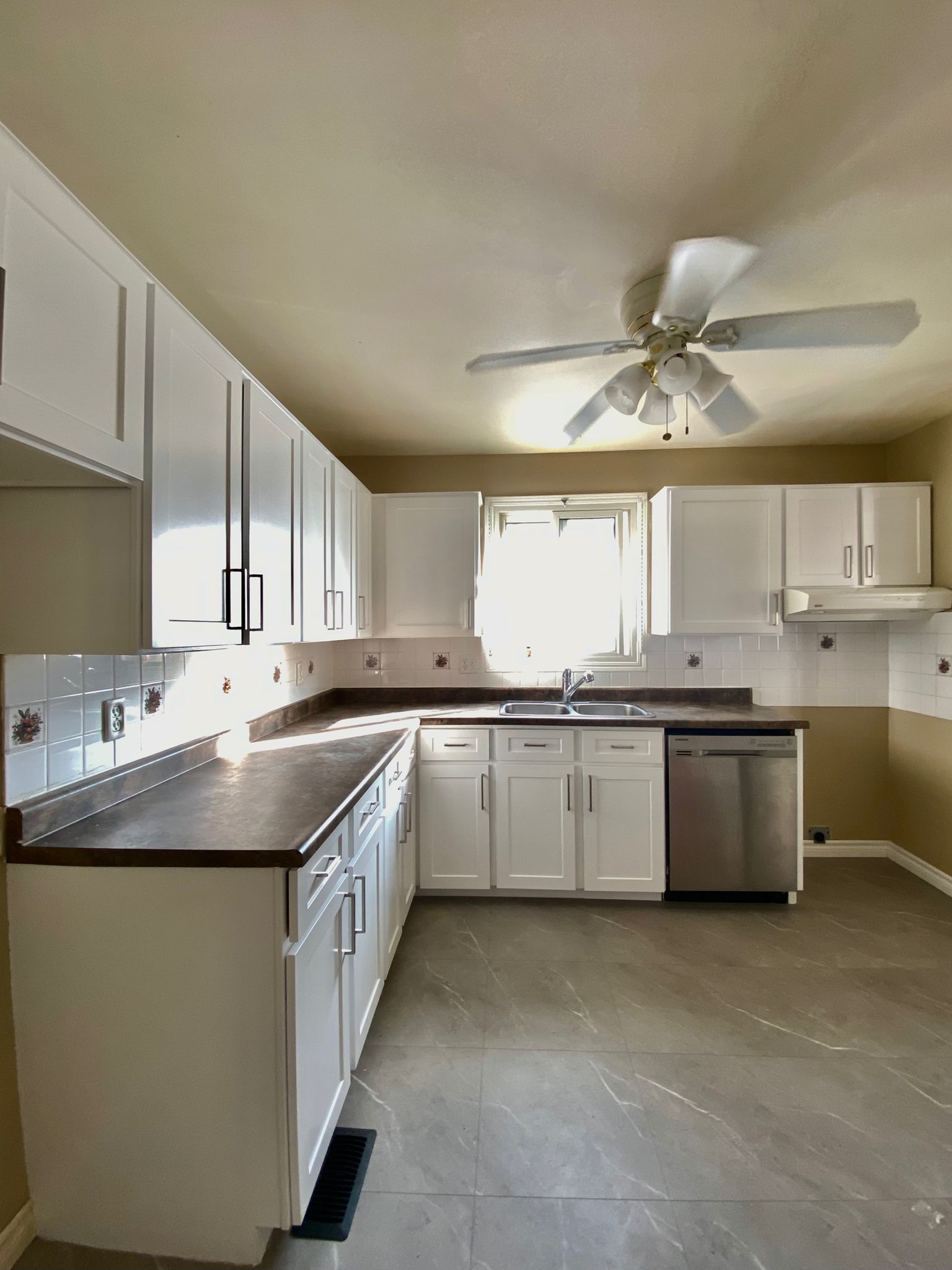 After refinish — Honey oak → white shaker, brushed nickel pulls