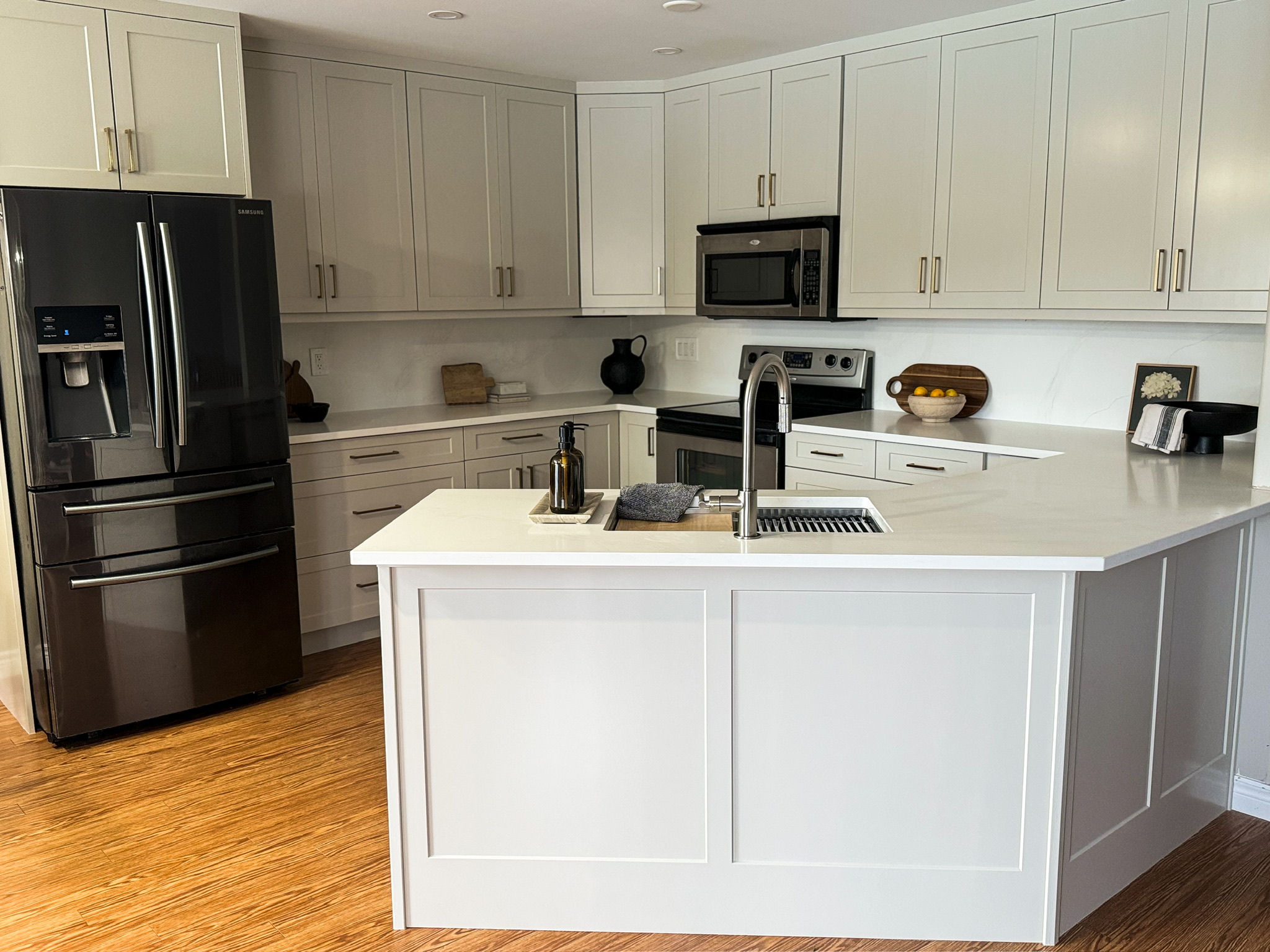 After refinish — Cathedral oak → warm greige shaker · cabinetry extended to the ceiling