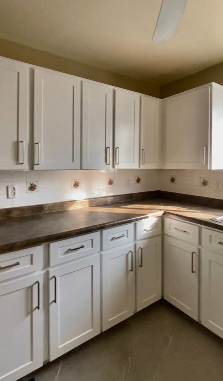 After refinish — Honey oak → white shaker, brushed nickel pulls