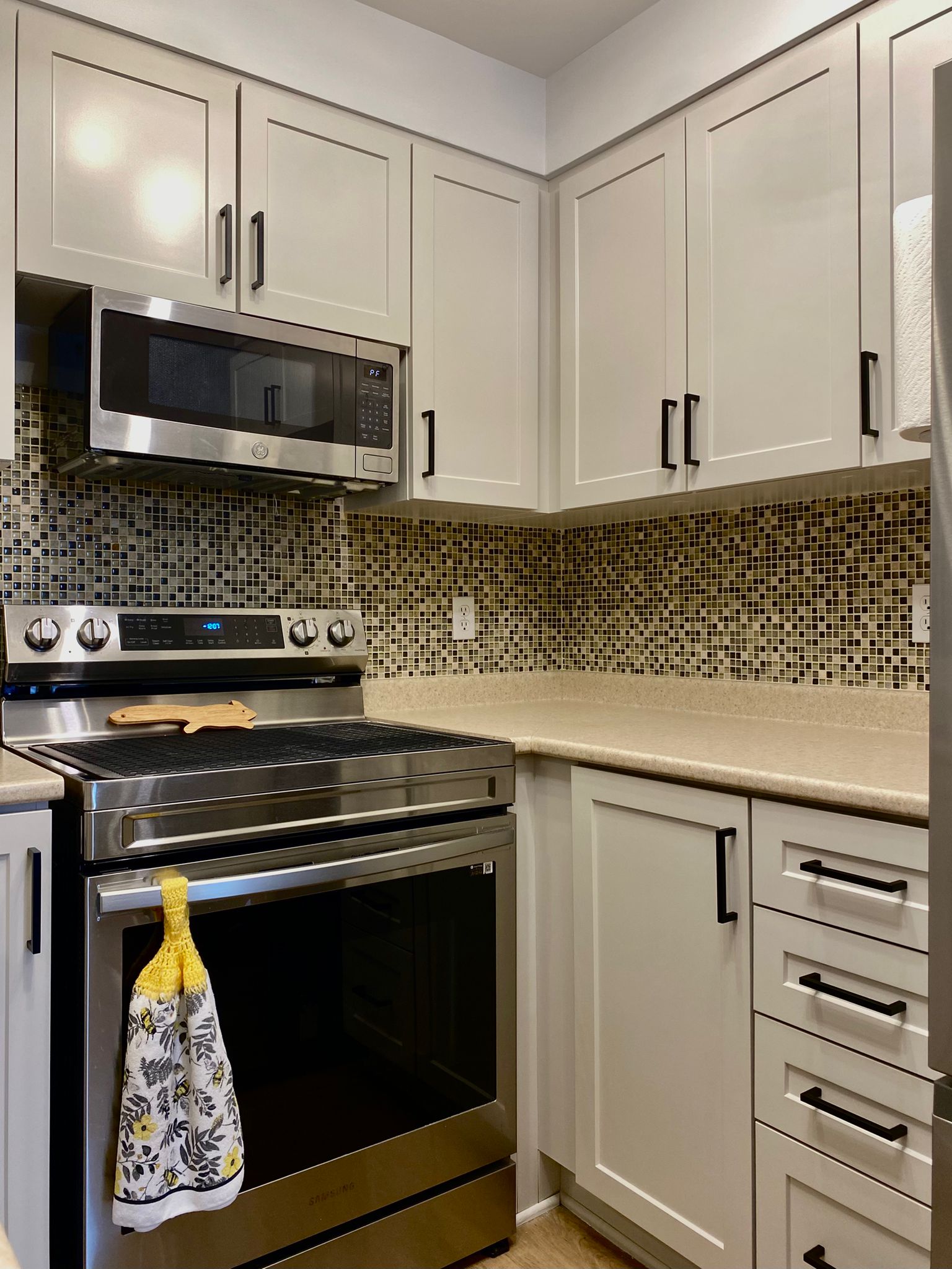 After refinish — Cathedral oak → white shaker, black hardware