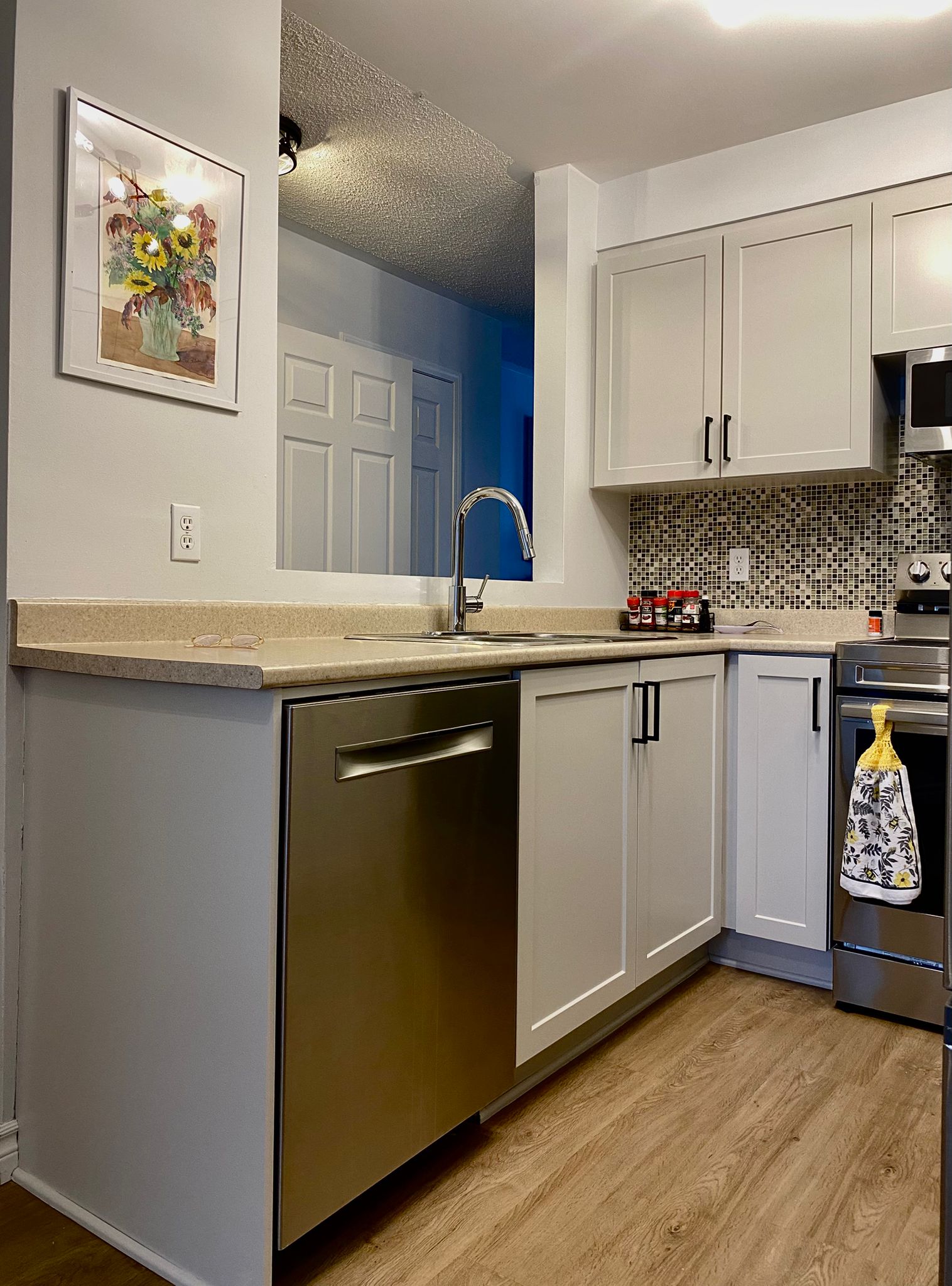 After refinish — Cathedral oak → white shaker, black hardware
