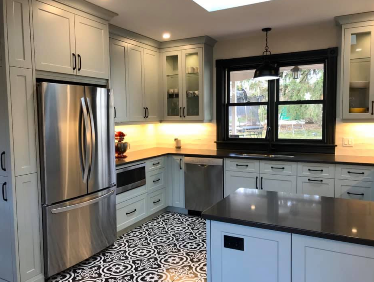 Belmont Custom Cabinetry โ white Shaker kitchen with patterned tile floor