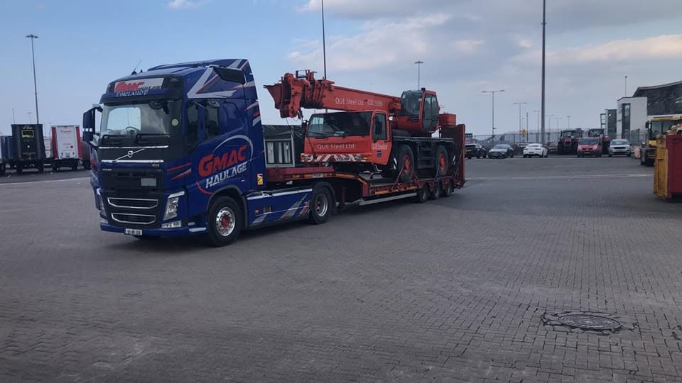 GMAC Haulage Volvo FH low-loader transporting a mobile crane at the port