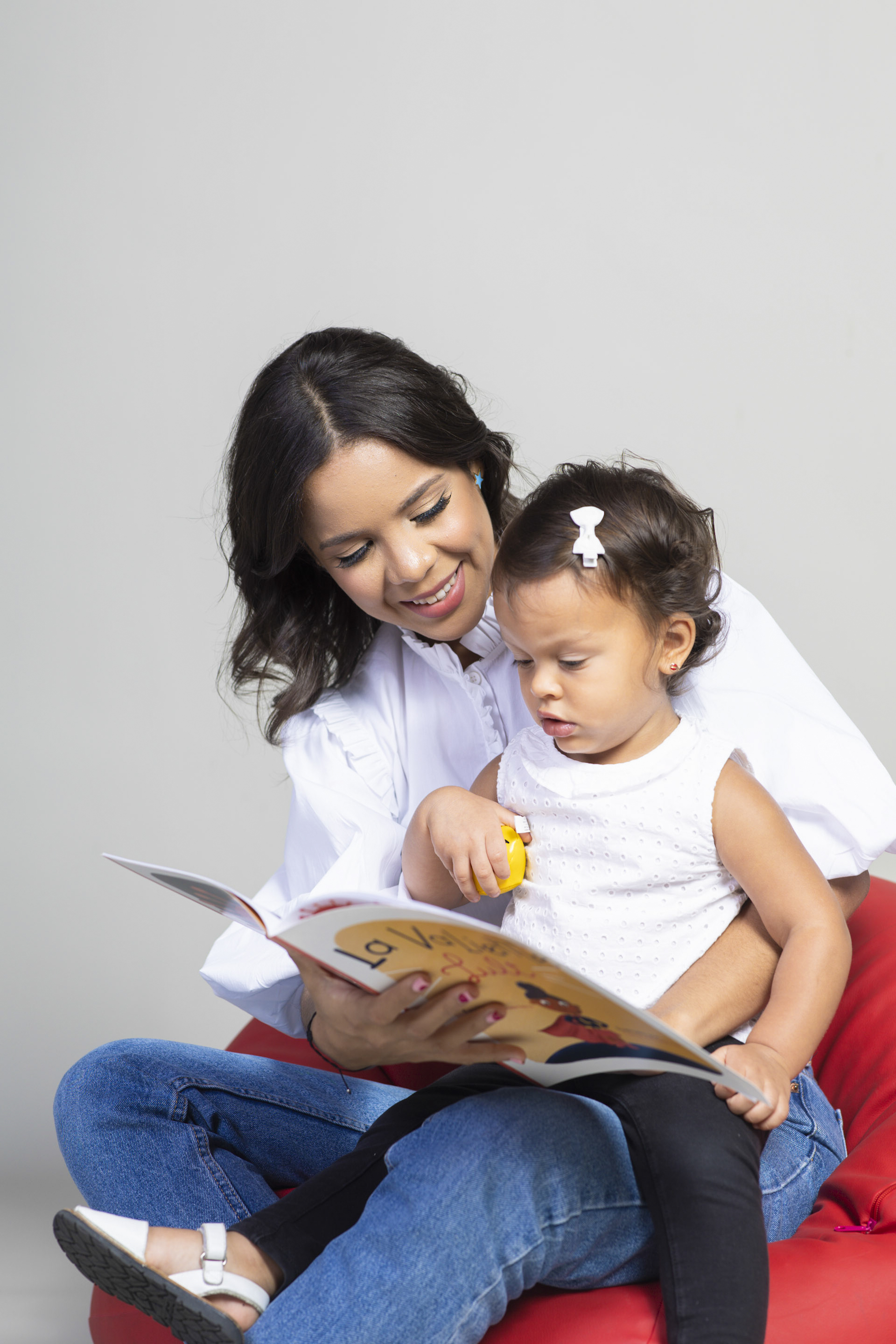 Natalia sharing a book closely with a young child