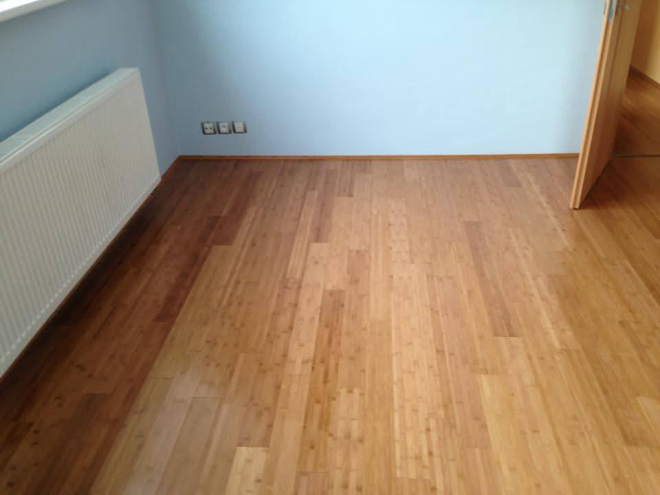 Warm bamboo flooring in a bedroom with pale blue walls