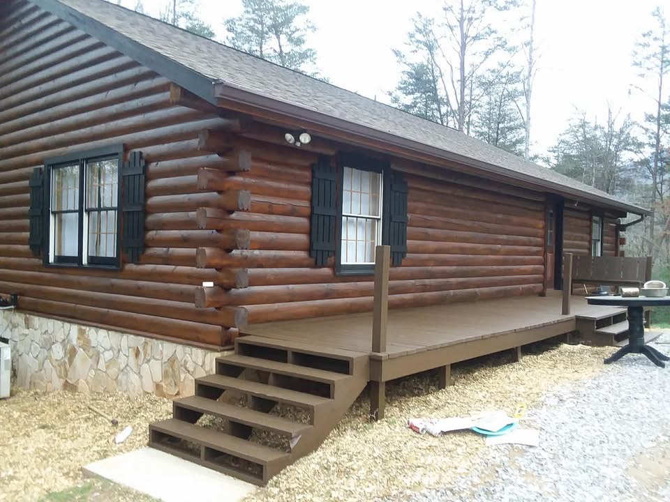Journey's Handyman project — Fresh stain & sealed logs with black window trim