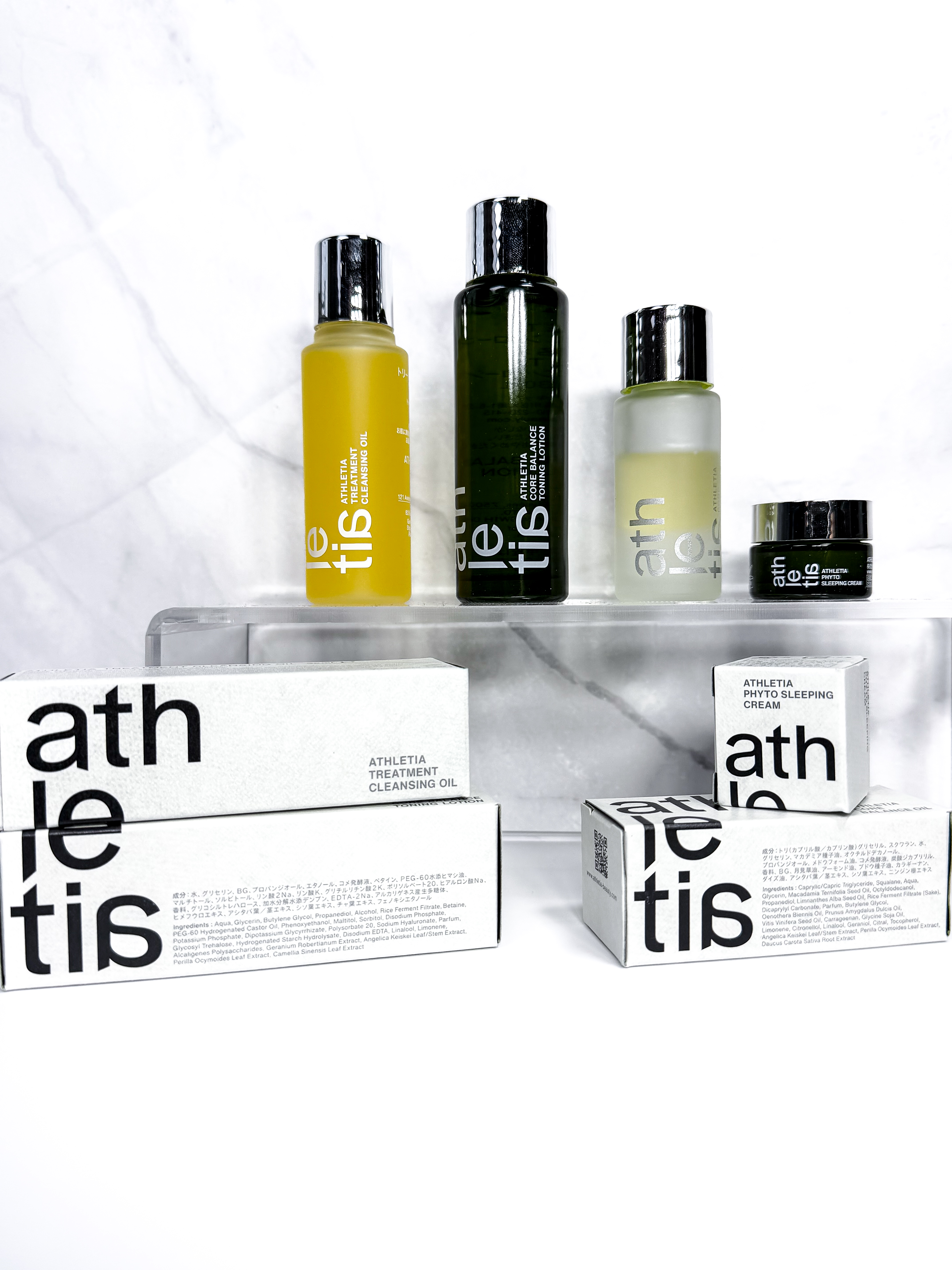 Athletia mini skincare set styled on a glass acrylic plinth in an editorial product feature by Beauty With Ju