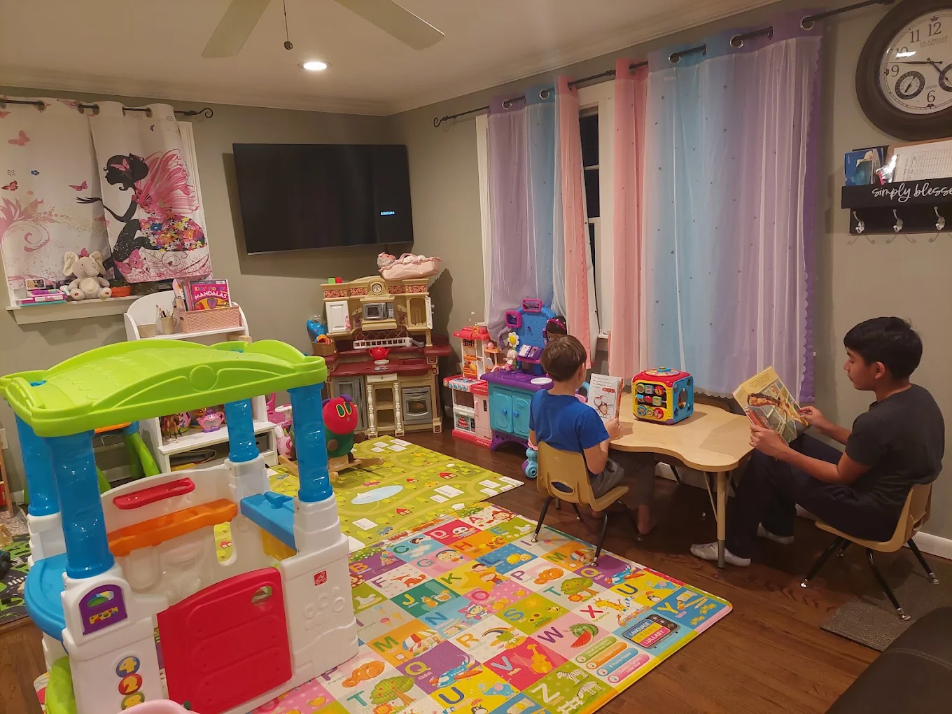Kids reading books together at a small table