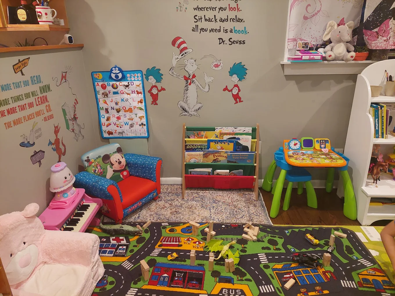 Dr. Seuss reading nook with books, alphabet chart, and cozy chair