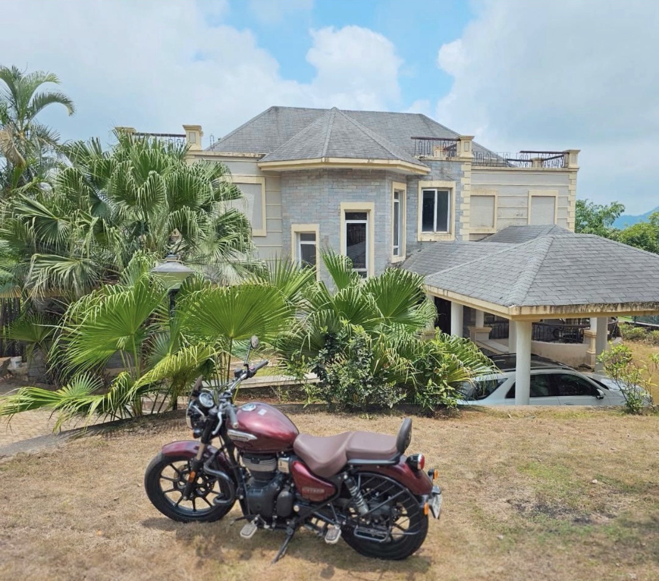 Villa surrounded by palm trees and nature in Amby Valley, Lonavala