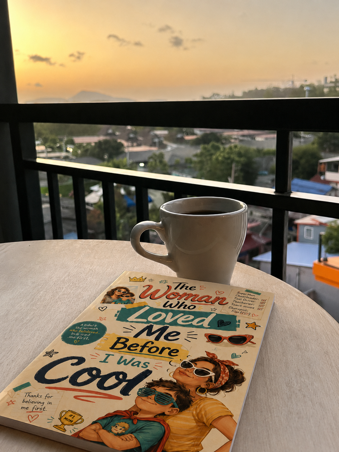 A custom Keepsake Storybook — 'The Woman Who Loved Me Before I Was Cool' — resting on a balcony table at sunset
