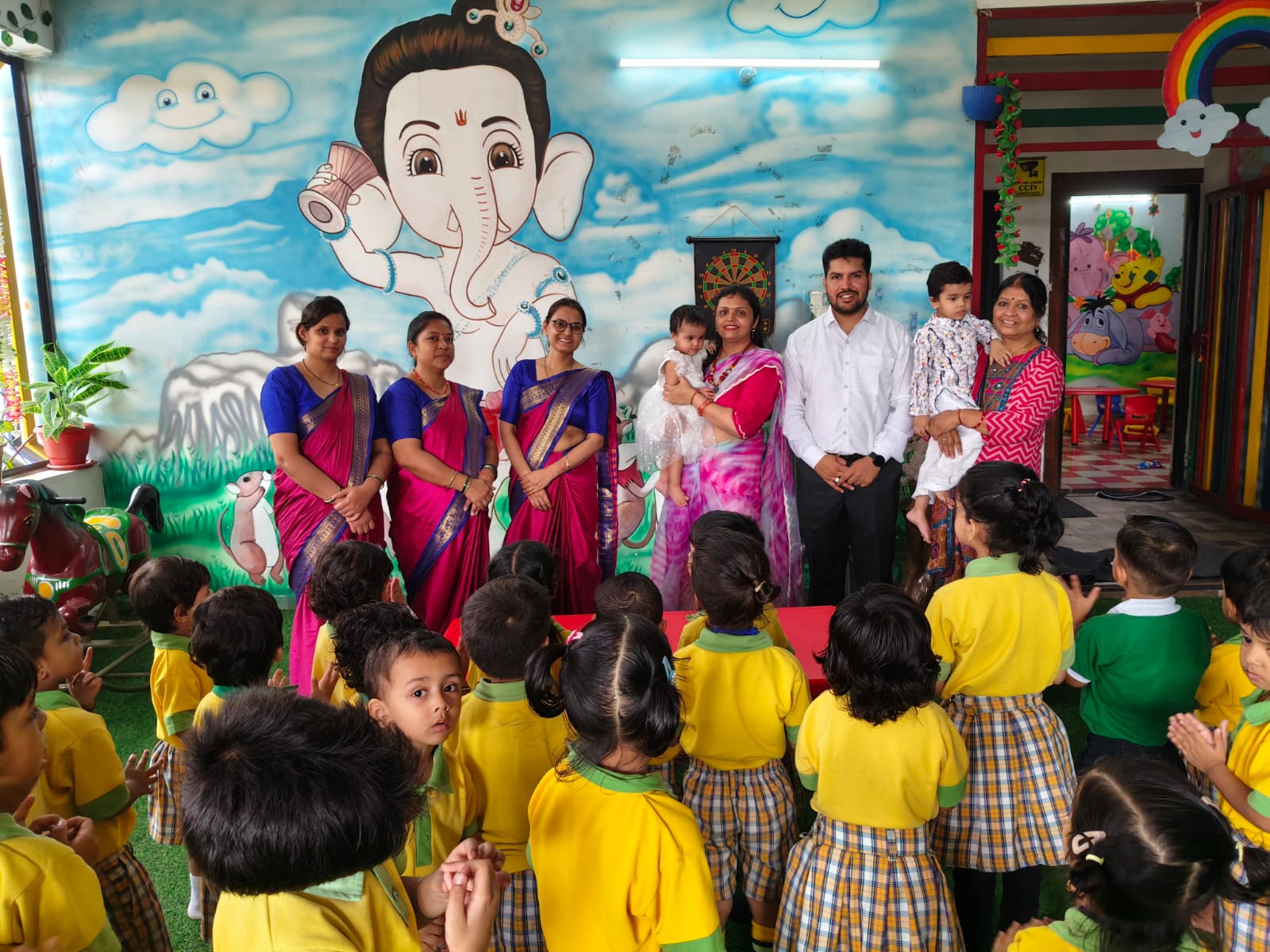 Teachers and staff with students assembly