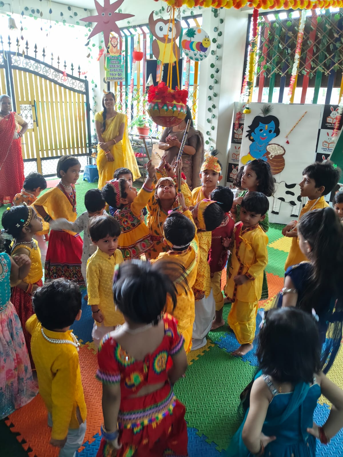 Janmashtami celebration with children around dahi handi