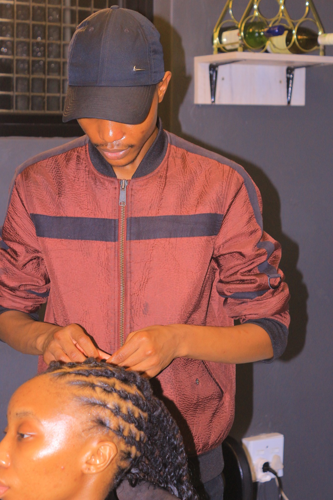 Loctician Carlocs working on client's locs