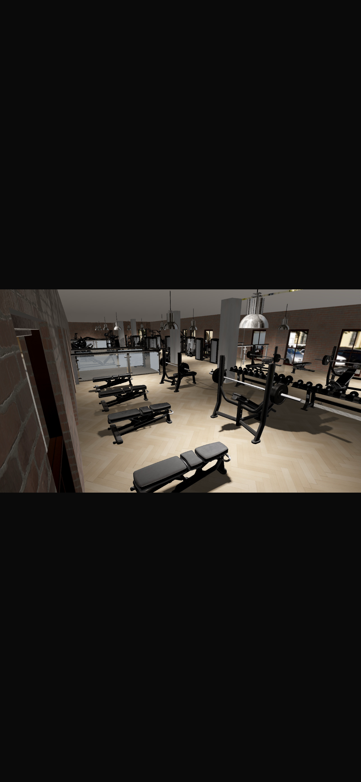 Free weights, racks and Olympic benches arranged in their own warm pool of light — herringbone floor, mirror walls and dark wood detailing.