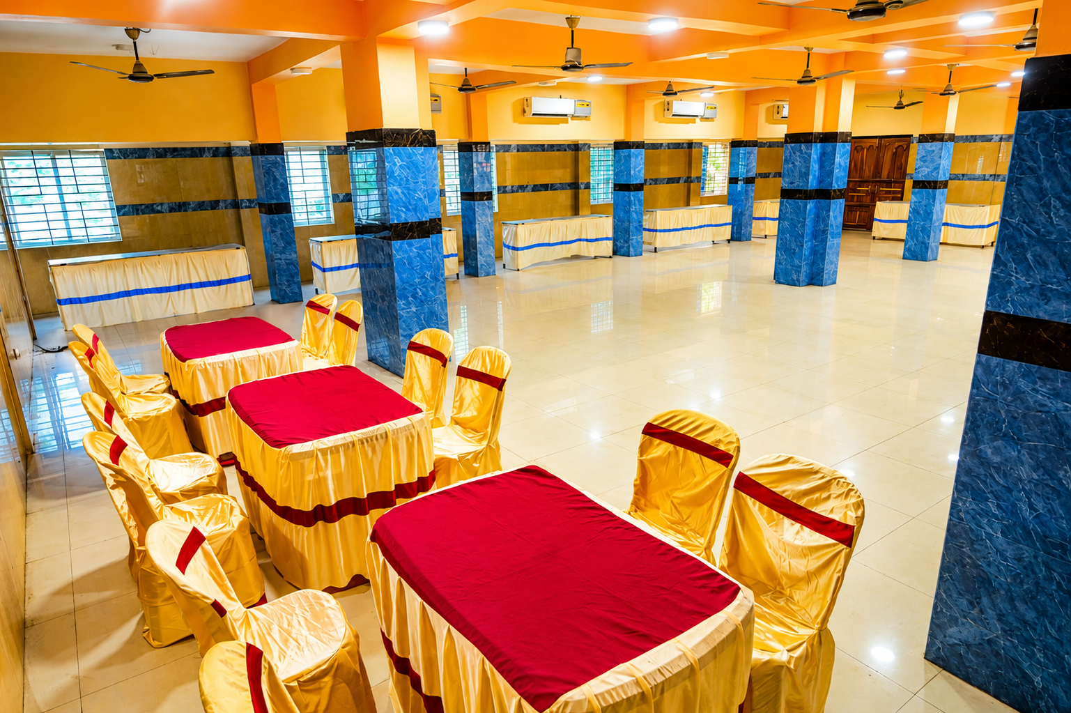 Spacious AC banquet hall with red & gold chairs