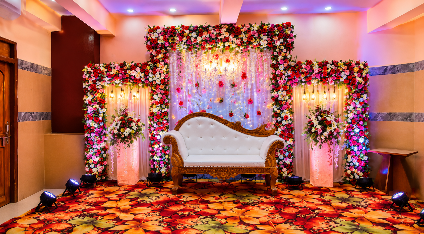 Intimate floral mandap with chandelier and ivory throne