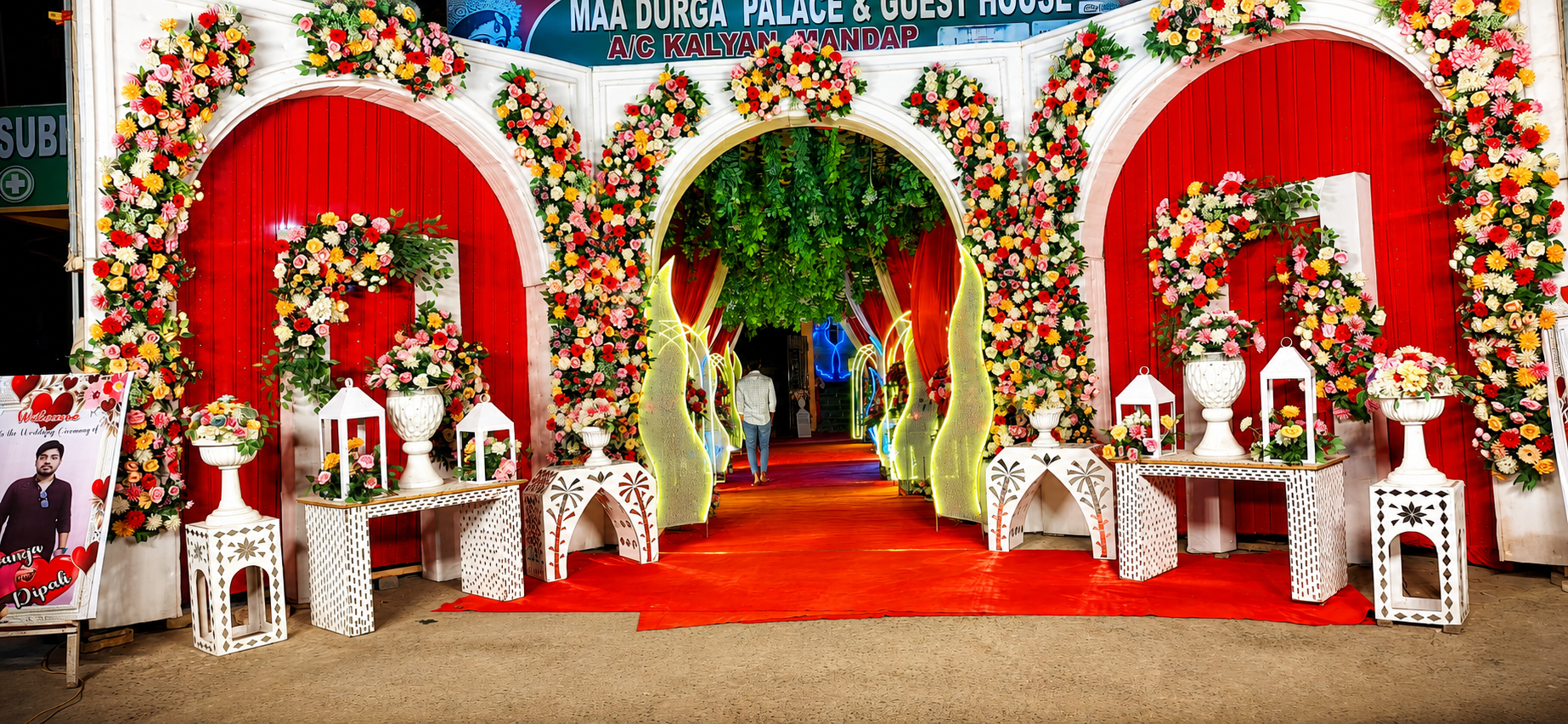 Triple red floral archway entrance to the Kalyan Mandap