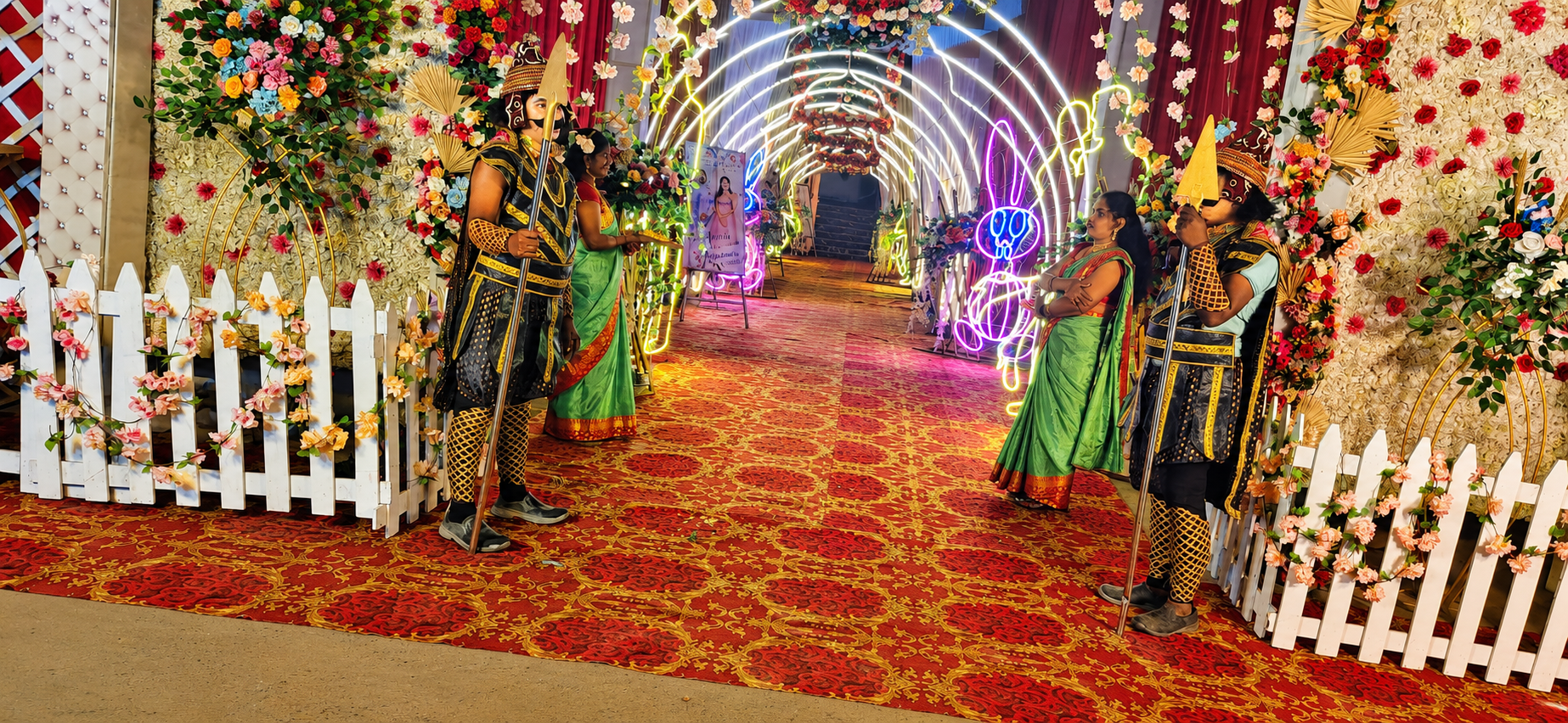 Traditional warrior guards welcoming guests at the lit-up entry tunnel