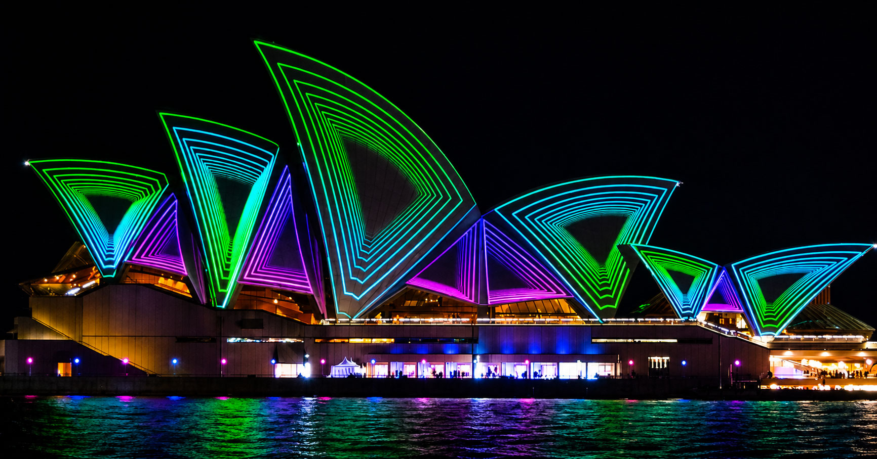 Vivid Sydney Opera House from a Vivid Cruises Sydney cruise Sydney Opera House sails illuminated in purple and blue Vivid Sydney light projections viewed from a Vivid Cruises Sydney harbour cruise at night