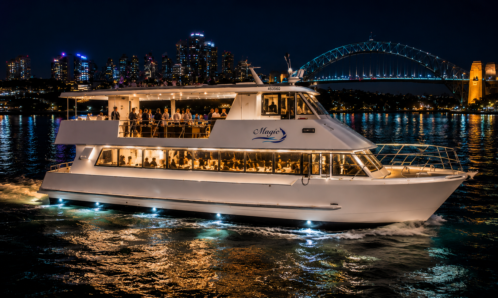 Vivid Cruise on Sydney Harbour Vivid Cruises Sydney vessel on Sydney Harbour with vibrant Vivid Sydney lights on the Harbour Bridge reflecting on the water at night
