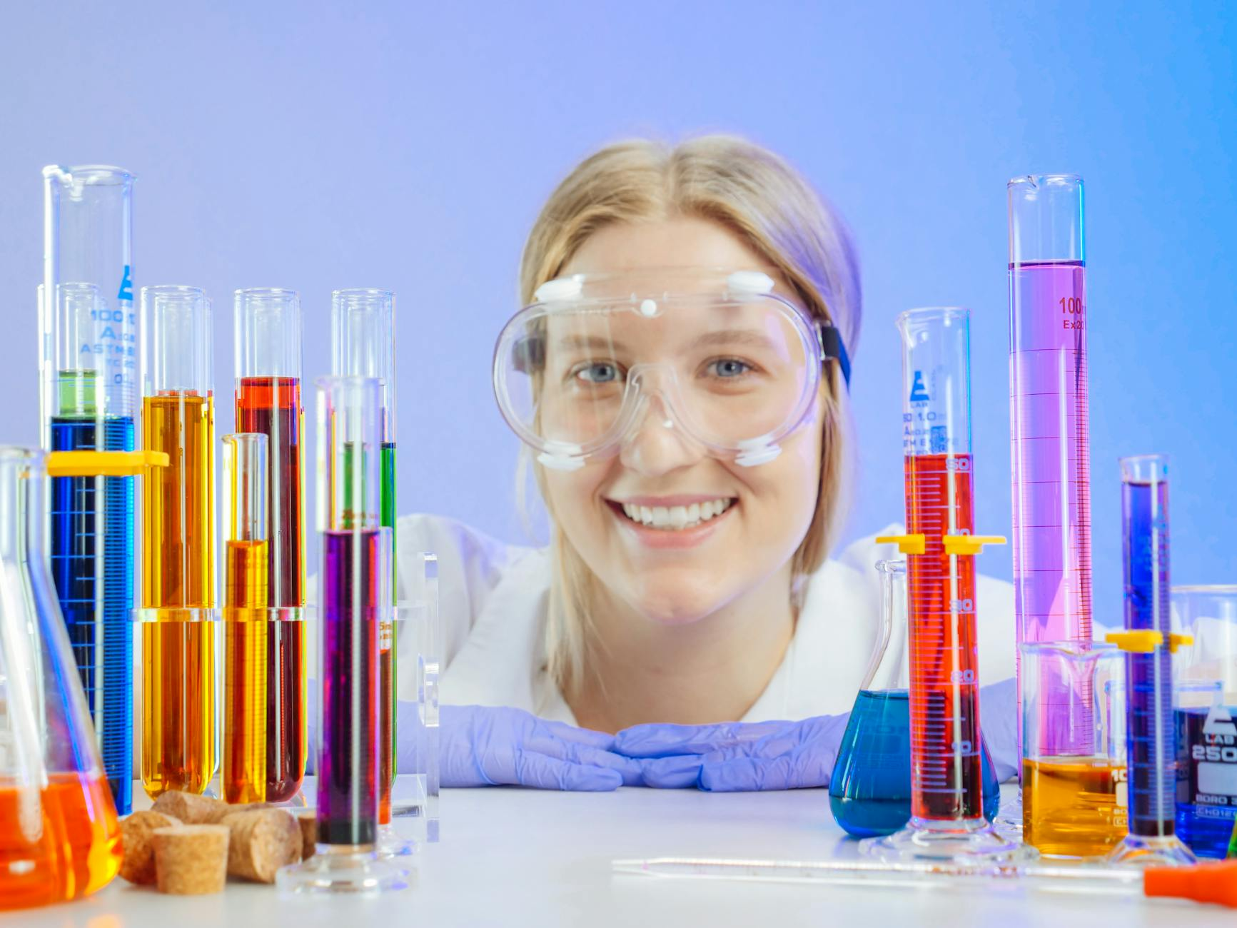 Scientist with colorful laboratory glassware