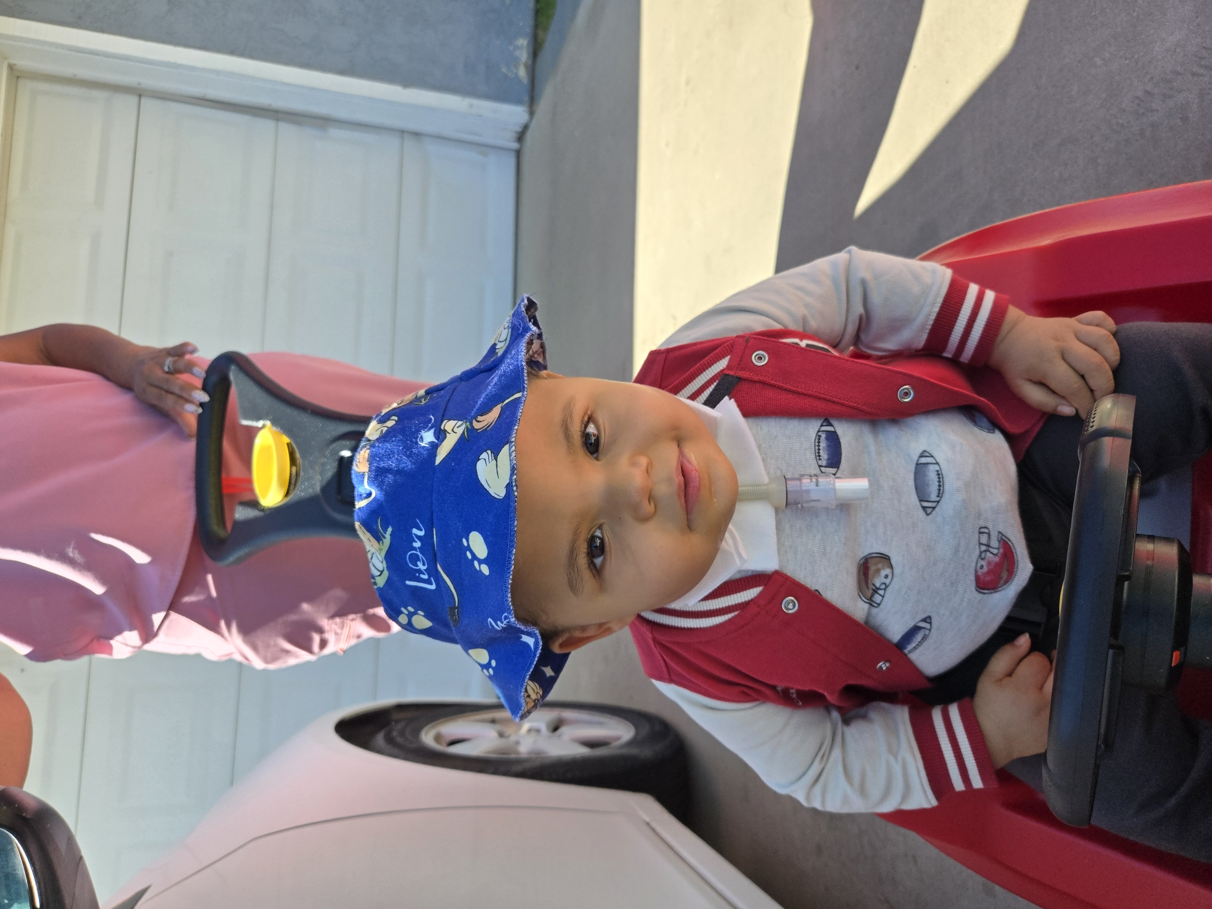 Out for a ride, hat on, ready to roll. 🚗💙