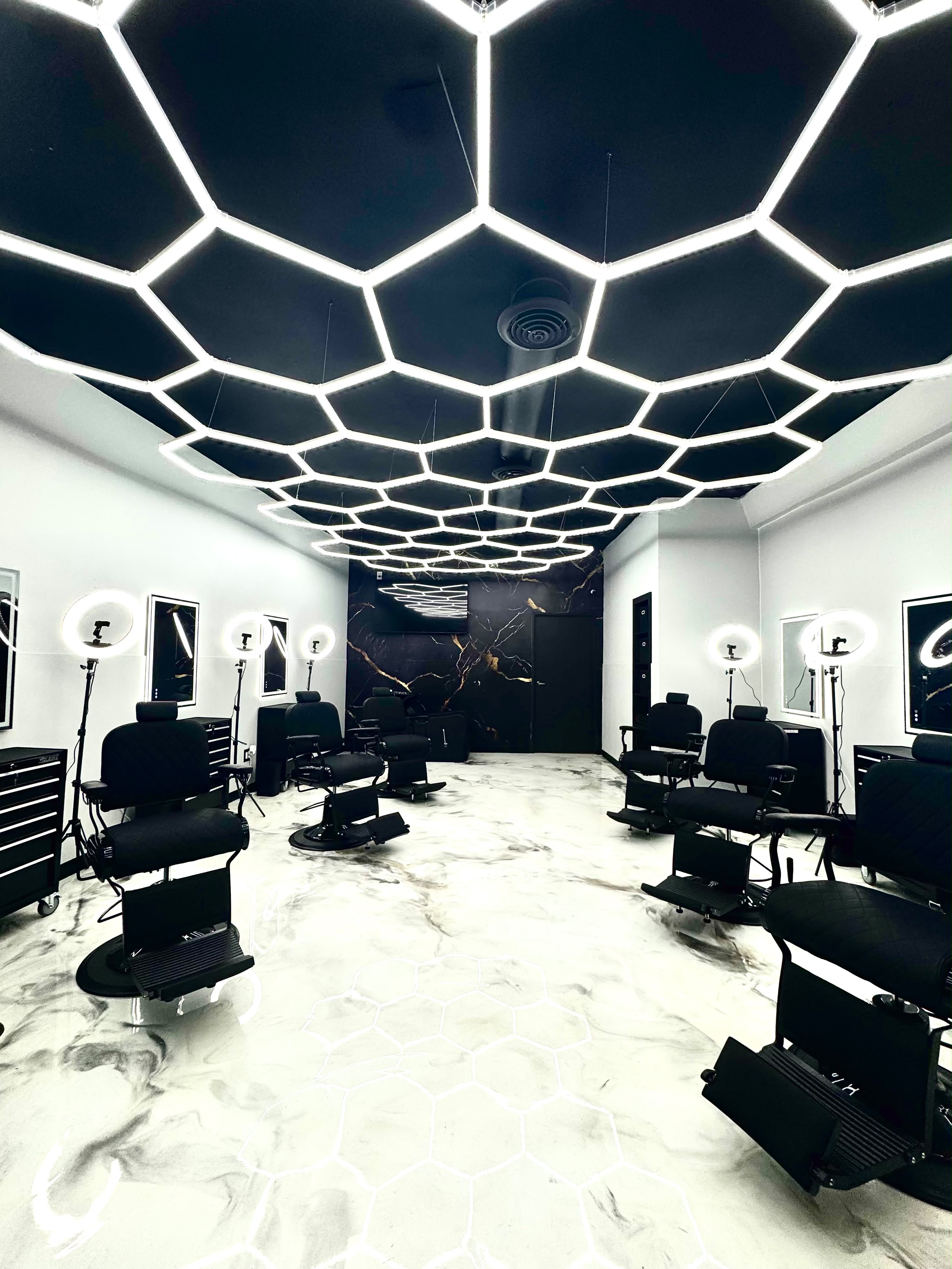 Monarch Cutz interior — hexagon LED ceiling and barber chairs