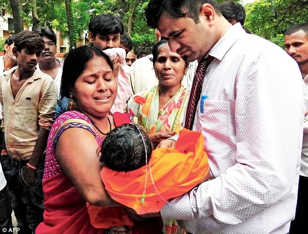 Dr. Kafeel Khan with a mother and child