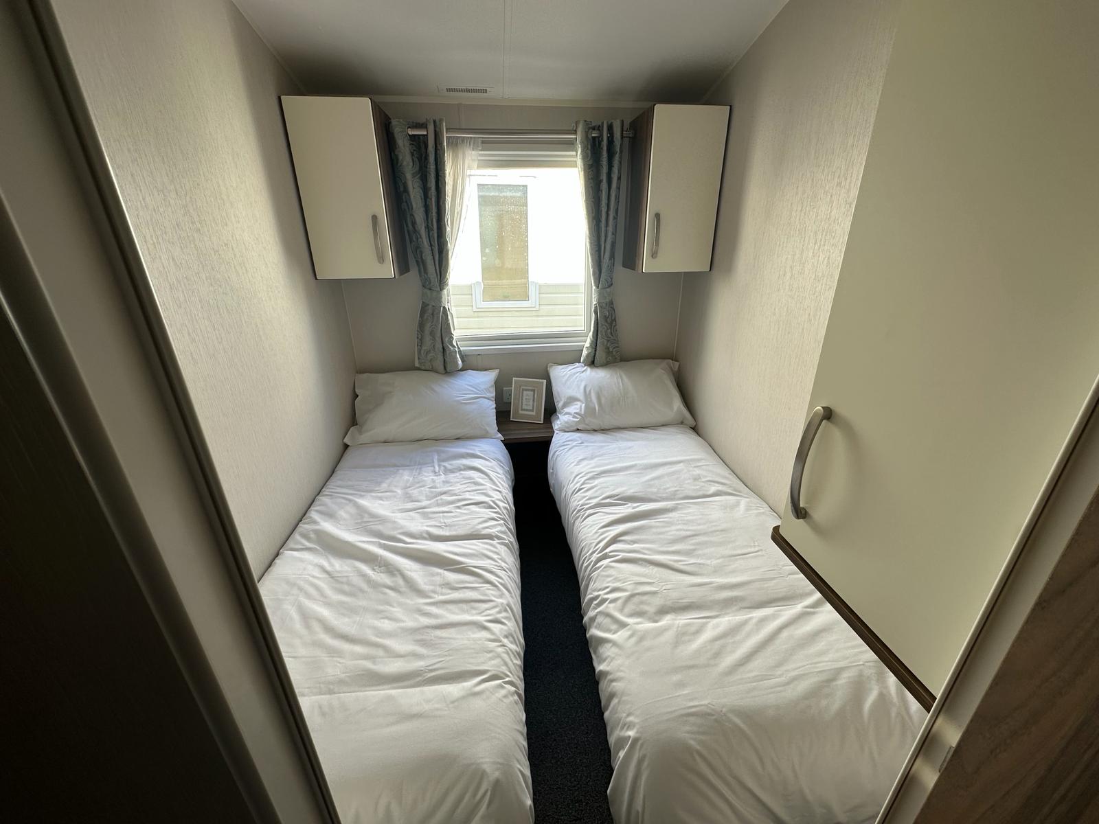 Twin bedroom with two single beds at Hoburne Park caravan
