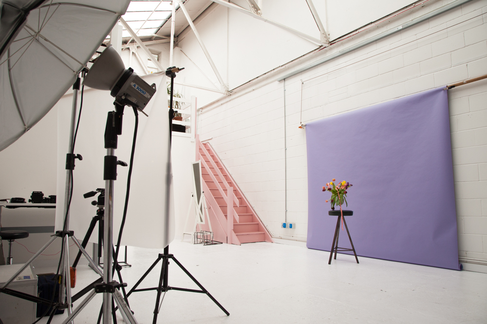 1,600 sq ft daylight photography studio with skylights, white walls and pink stairs at Peanut Factory, Hackney Wick
