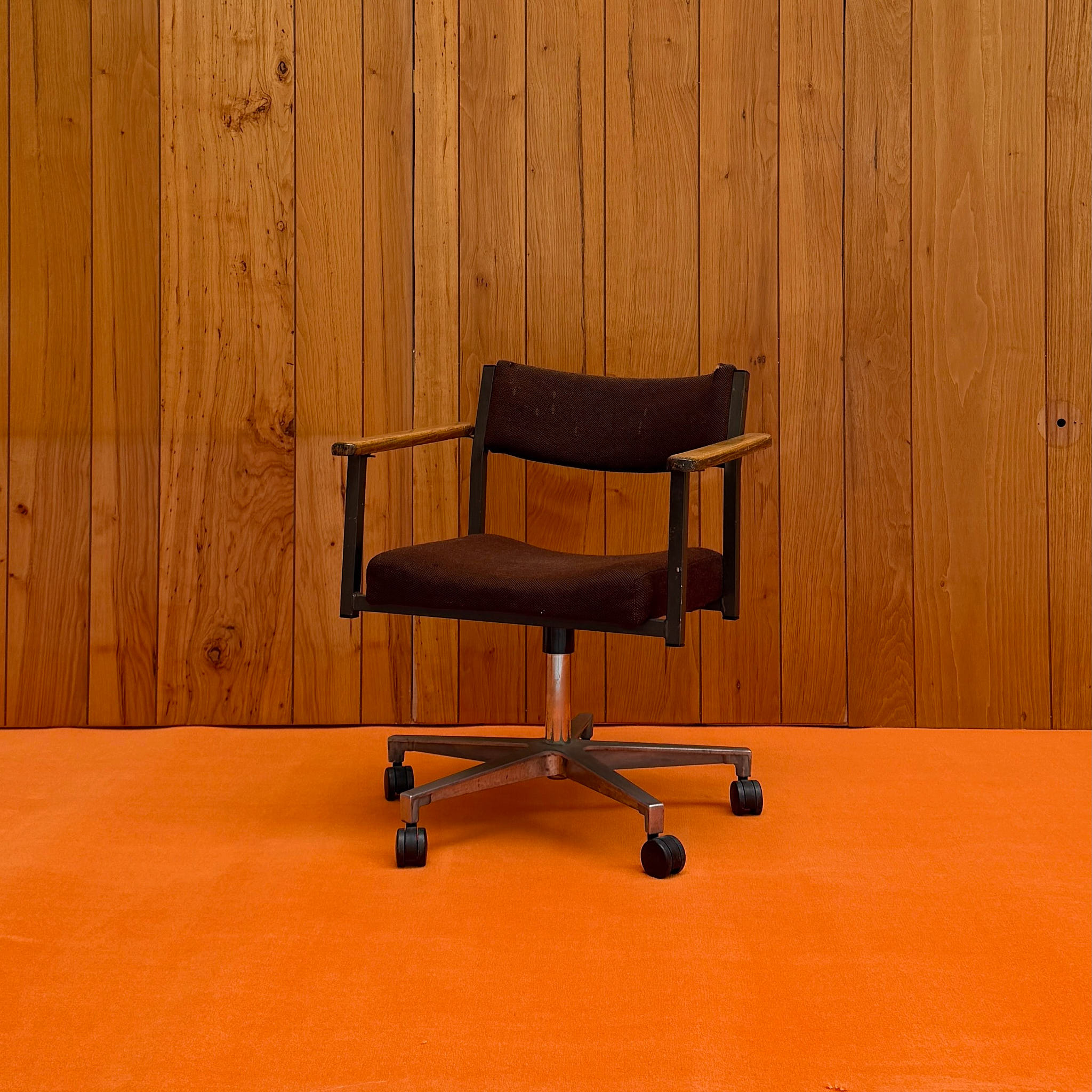 Studio prop chair on warm wood backdrop — available on-site at Peanut Factory Studio