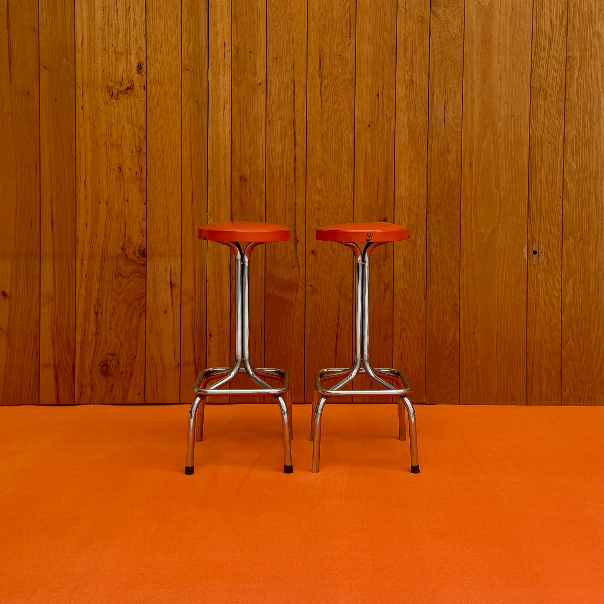 Pair of vintage chrome and orange vinyl bar stools — available on-site at Peanut Factory Studio