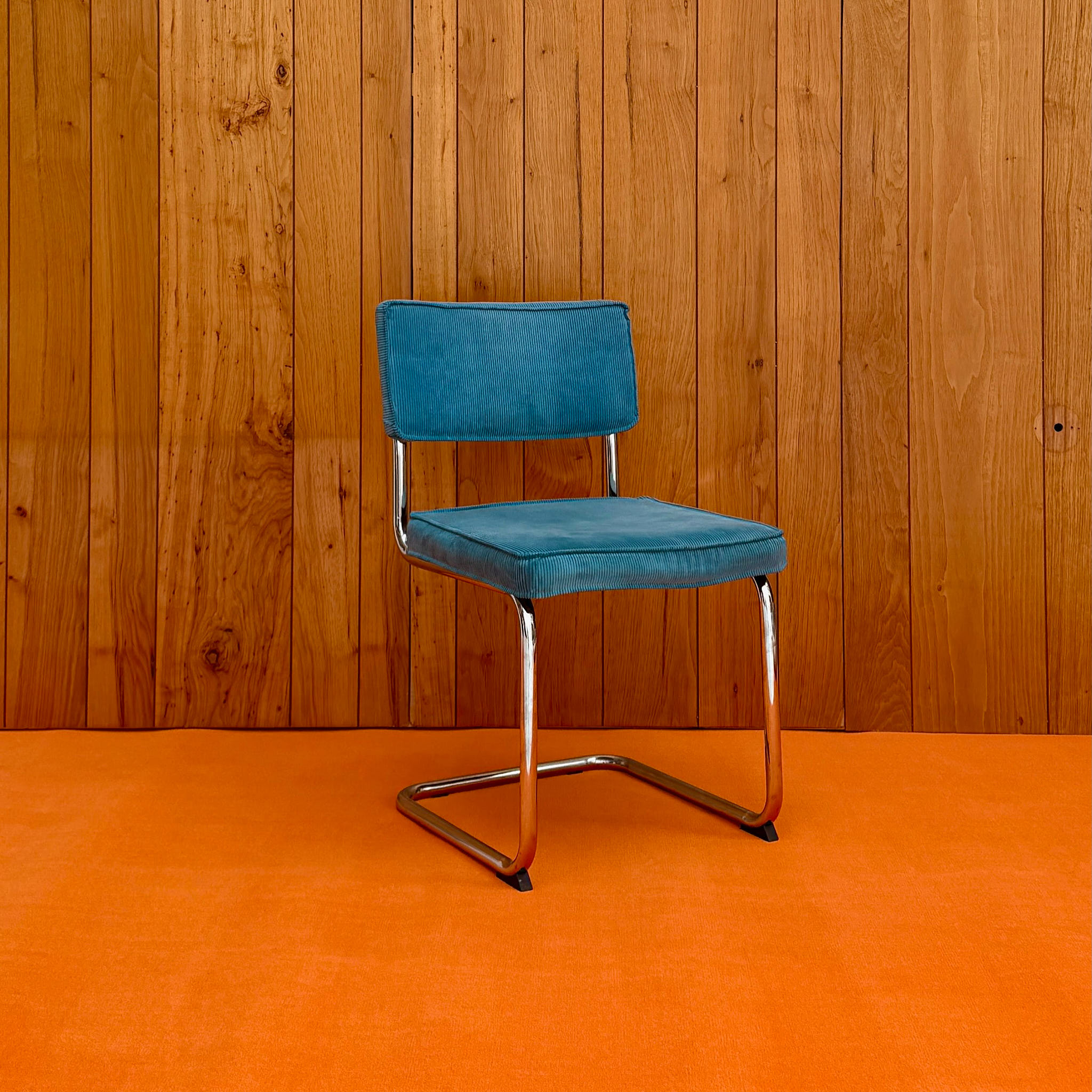 Blue corduroy cantilever chair with chrome frame — available on-site at Peanut Factory Studio, Hackney Wick