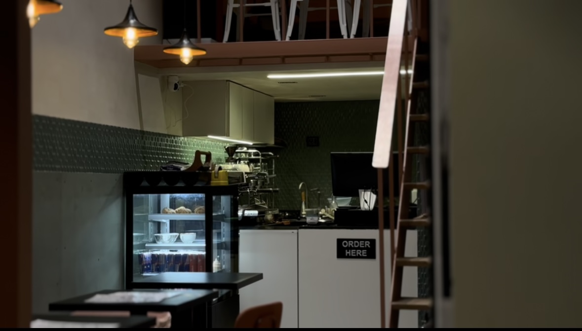 Inside OROMA — warm pendant lights and the espresso bar