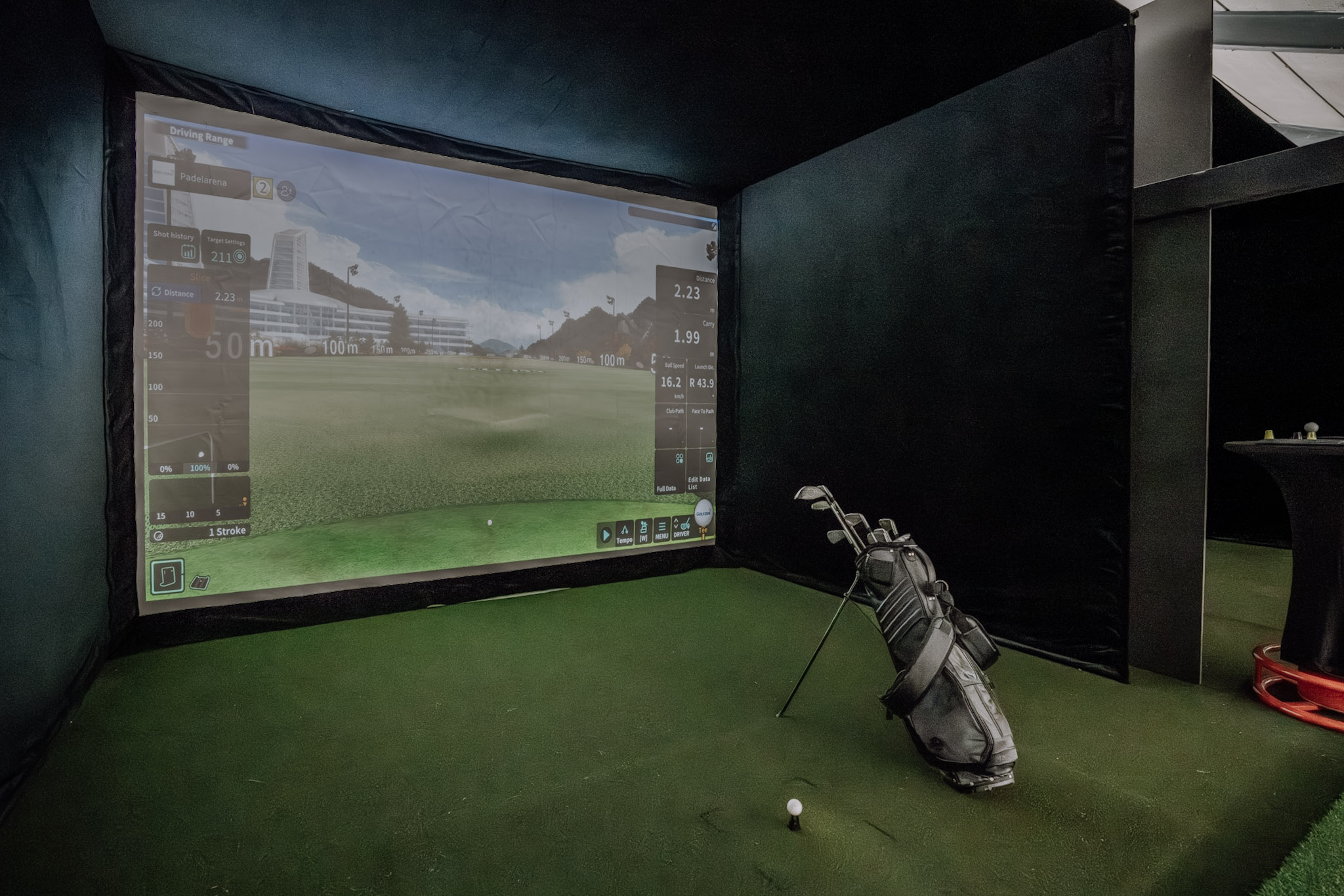 Indoor golf simulator with driving range view at Padelarena Wädenswil