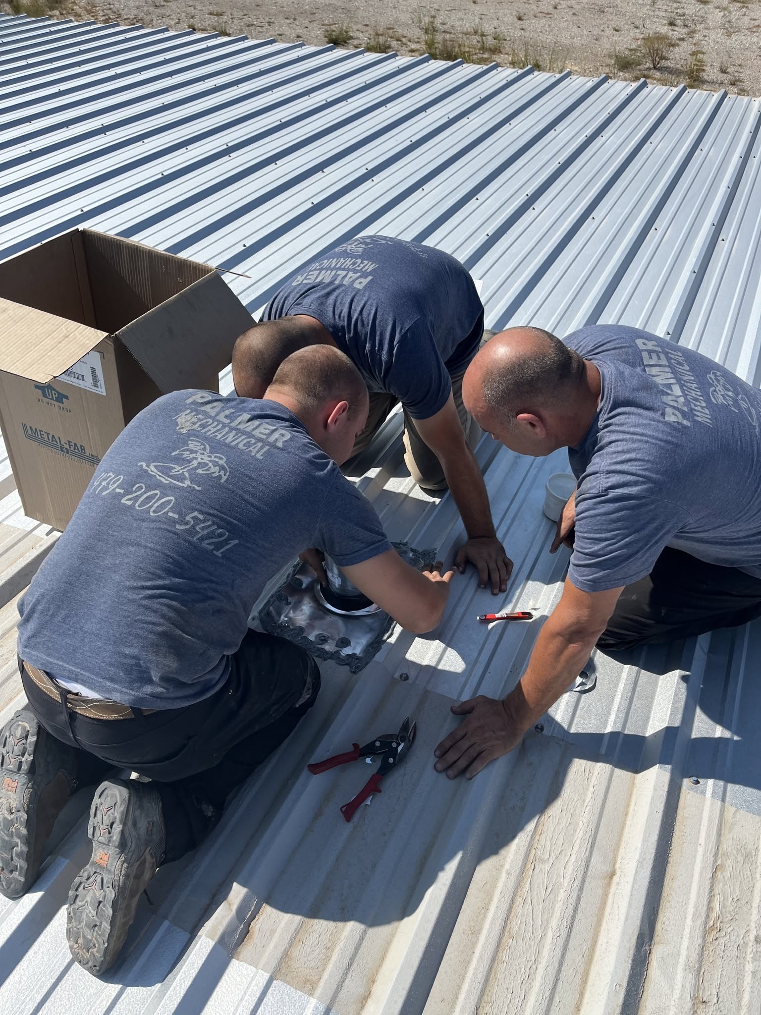 Palmer HVAC team — three technicians installing commercial rooftop HVAC in Northwest Arkansas