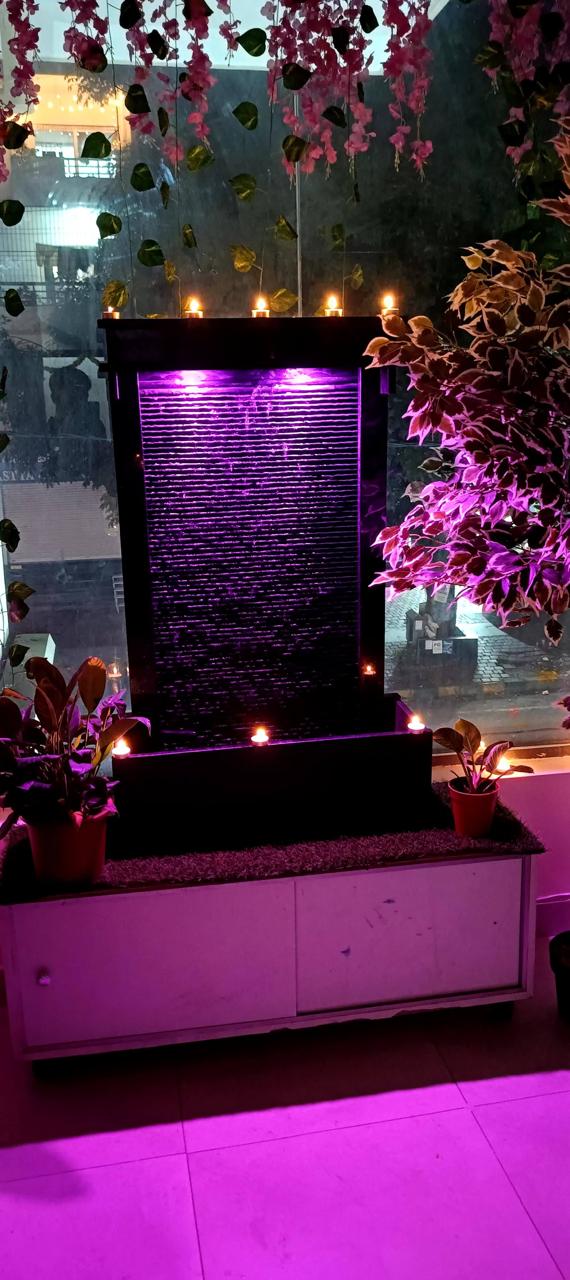 Serene reception area at Jantikar Ayurveda with waterfall feature