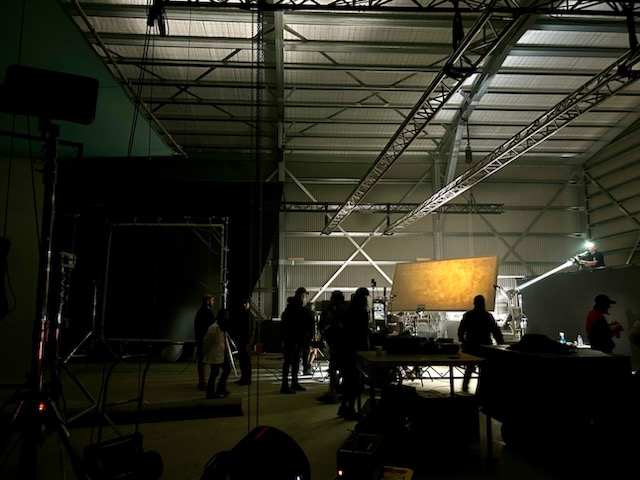 Night lighting setup with crew silhouettes around an illuminated panel